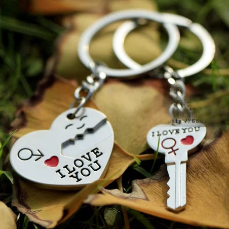Close-up of matching heart keyrings for couples showing red and silver metal finish, perfect anniversary present.