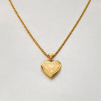 Gold heart locket with delicate chain display