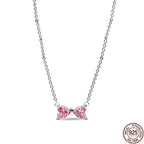 Heart pendant necklace displayed next to flowers