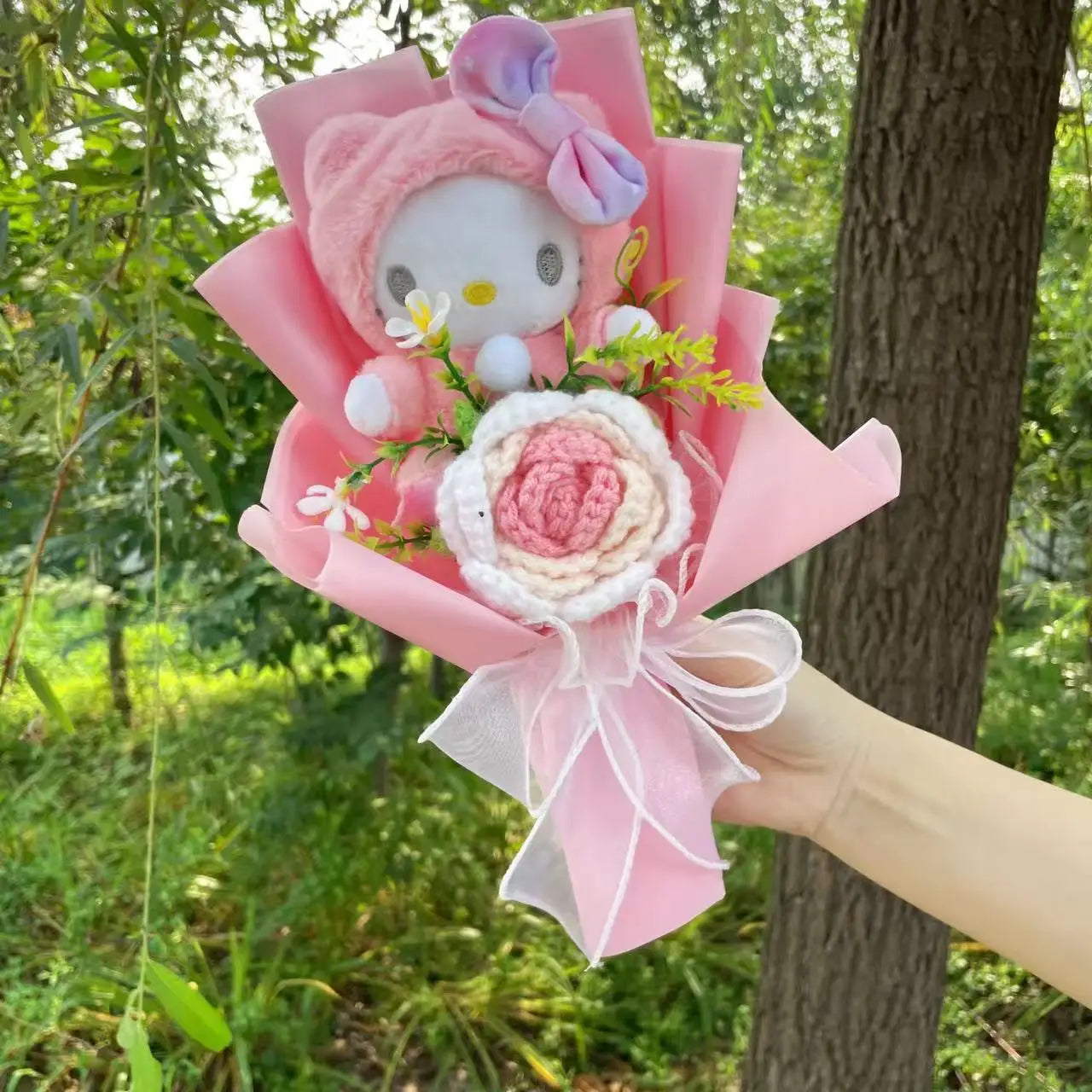 Plush Hello Kitty holding heart shaped bouquet