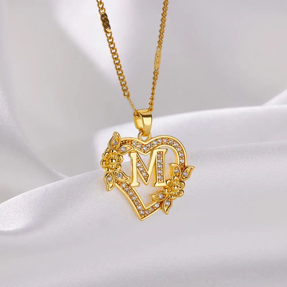 Personalized heart initial necklace on white background